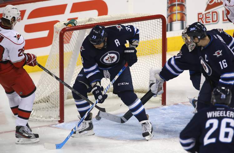 TREVOR HAGAN / WINNIPEG FREE PRESS
Carolina Hurricanes' Alexander Semin (28) puts the puck past Winnipeg Jets' Dustin Byfuglien (33) and goaltender Ondrej Pavelec (31) early in the first period of NHL action at the MTS Centre in Winnipeg, Saturday.