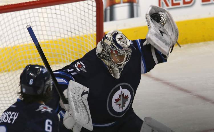 TREVOR HAGAN / WINNIPEG FREE PRESS
Winnipeg Jets' goaltender Ondrej Pavelec flashes the leather against the Carolina Hurricanes.