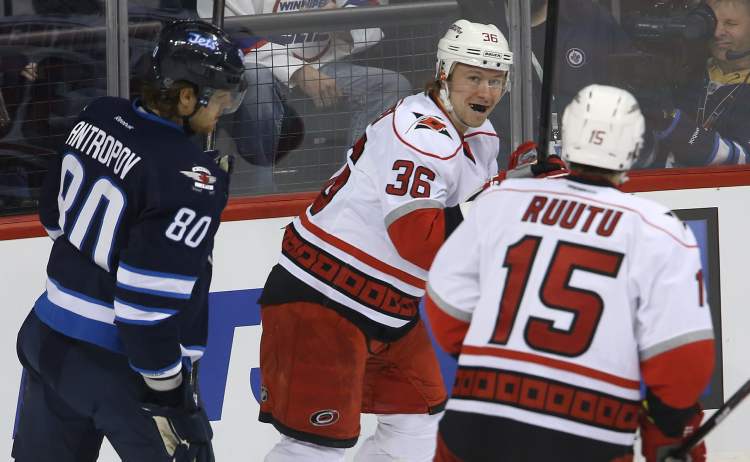 TREVOR HAGAN / WINNIPEG FREE PRESS
Winnipeg Jets' Nik Antropov looks on as Carolina Hurricanes' Jussi Jokinen (36) and Tuomo Ruutu celebrate a goal by Jokinen during the first period.