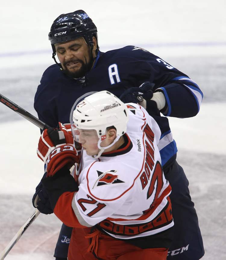 TREVOR HAGAN / WINNIPEG FREE PRESS
Winnipeg Jets' Dustin Byfuglien (33) bumps Carolina Hurricanes' Drayson Bowman (21) at centre ice during the third period.