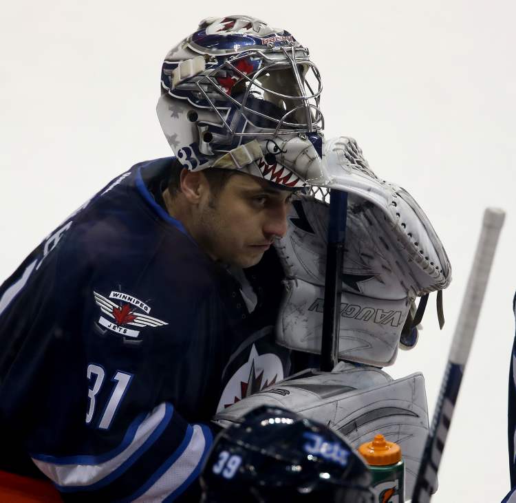 TREVOR HAGAN / WINNIPEG FREE PRESS
Winnipeg Jets' goaltender Ondrej Pavelec (31) rests at the bench during a break in third-period action.
