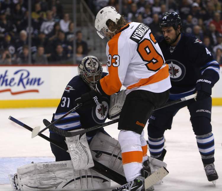 TREVOR HAGAN / WINNIPEG FREE PRESS
Winnipeg Jets' goaltender Ondrej Pavelec (31) saves the puck with Philadelphia Flyers Jakub Voracek (93) on the doorstep during the first period of Saturday afternoon's game.