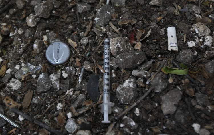 JOE BRYKSA / WINNIPEG FREE PRESS
A syringe on the ground outside a Furby Street rooming house.