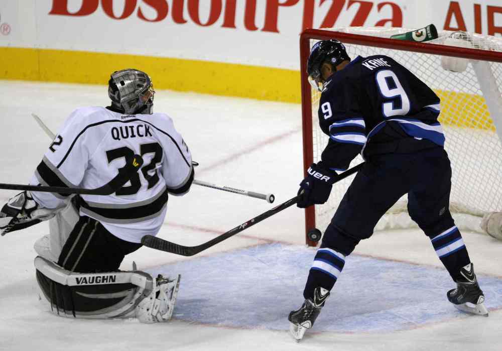 JOE BRYKSA / WINNIPEG FREE PRESS
Winnipeg Jets Evander Kane swipes at a loose puck behing Kings goaltender Jonathan Quick during the first period.