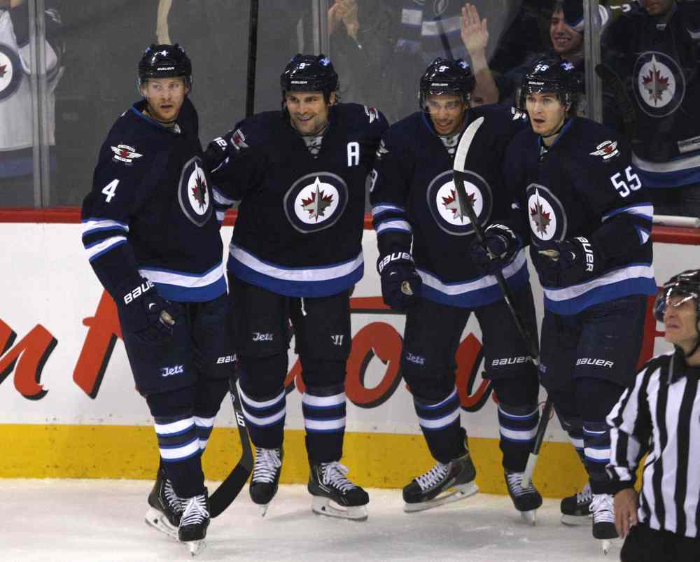 JOE BRYKSA / WINNIPEG FREE PRESS
Winnipeg Jets (from left) Paul Postma, Mark Stuart, Evander Kane, and Mark Scheifele celebrate Kane's first-period goal.