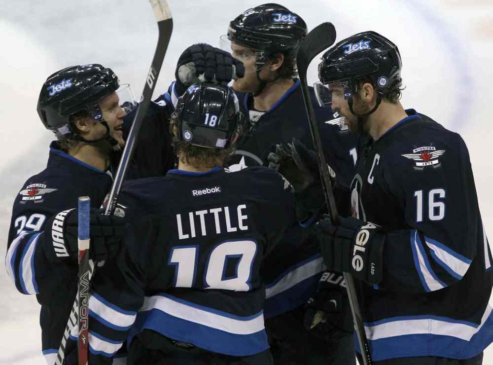 JOE BRYKSA / WINNIPEG FREE PRESS
Winnipeg Jets (from left) Tobias Enstrom, Bryan Little, Jim Slater and Andrew Ladd celebrate the team's late empty-net goal in the third period, giving the Jets a 5-3 win over the Los Angeles Kings.