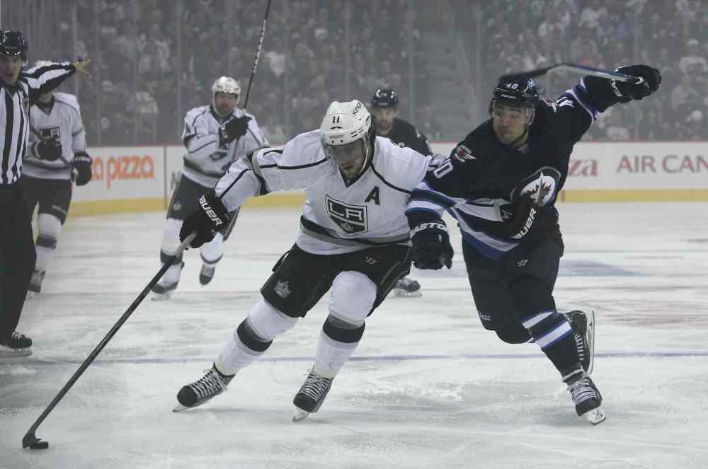 MIKE DEAL / WINNIPEG FREE PRESS
Devin Setoguchi (40) of the Winnipeg Jets tries to slow down Los Angeles Kings' Anze Kopitar (11) in the first period of Friday night's home opener at the MTS Centre.