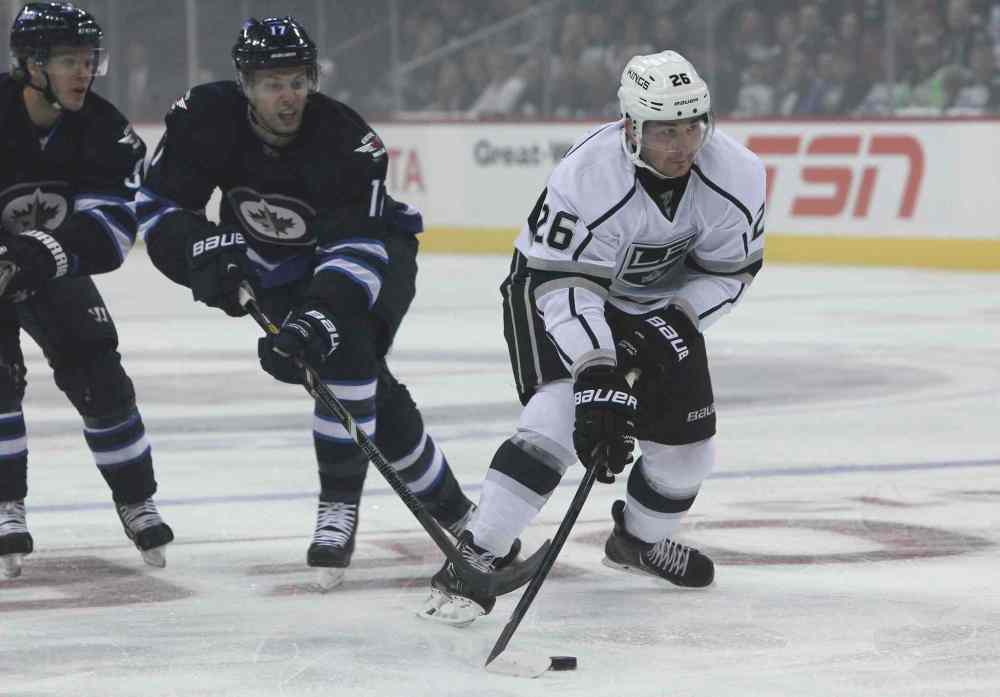 MIKE DEAL / WINNIPEG FREE PRESS
Winnipeg Jets' James Wright (17) tries to slow down Los Angeles Kings' Slava Voynov (26) in the first period.