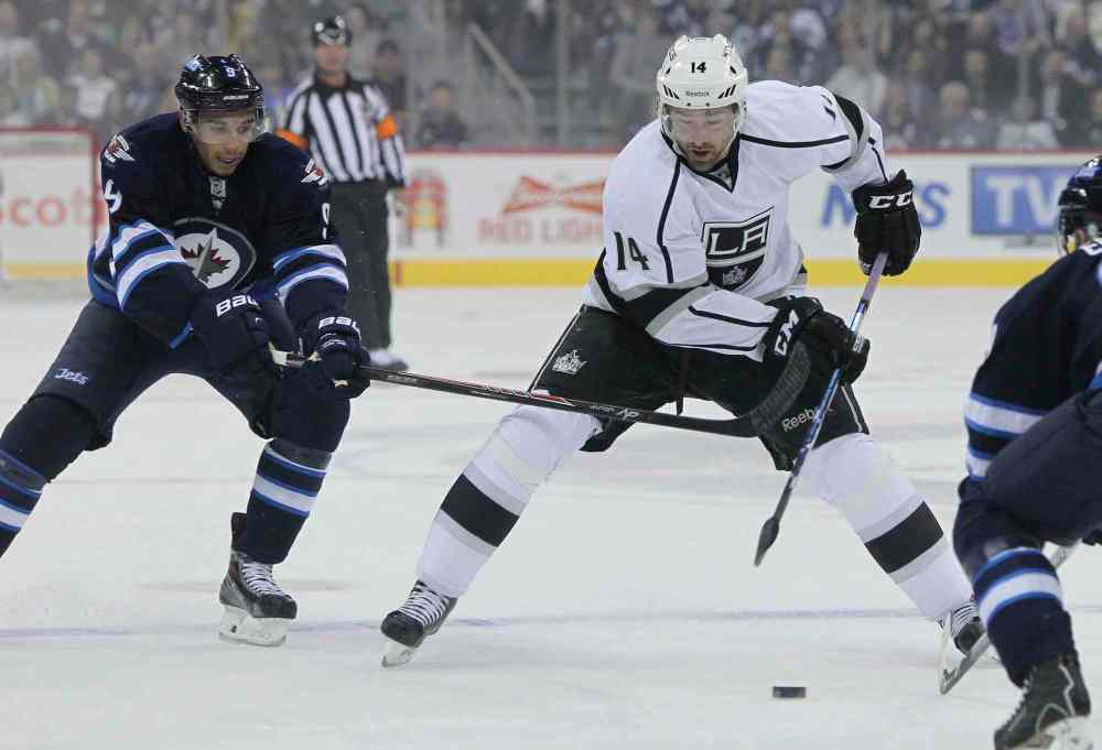 MIKE DEAL / WINNIPEG FREE PRESS
Winnipeg Jets' Evander Kane (9) tries to slow down Los Angeles Kings' Justin Williams (14) in the first period.