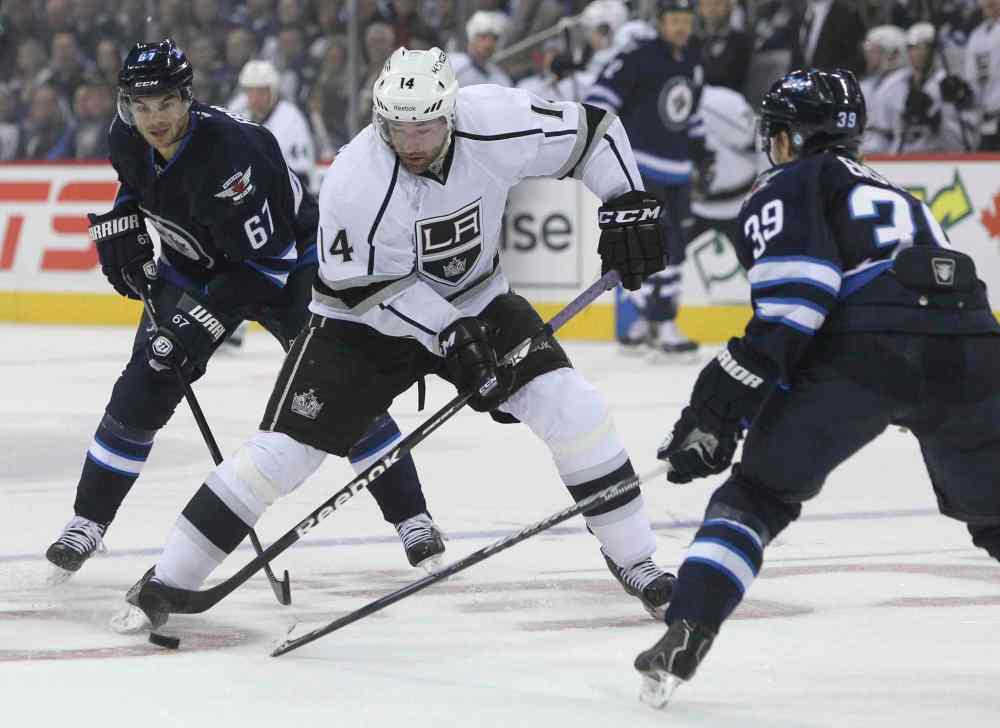 MIKE DEAL / WINNIPEG FREE PRESS
Tobias Enstrom defends against Justin Williams (14) in the first period.