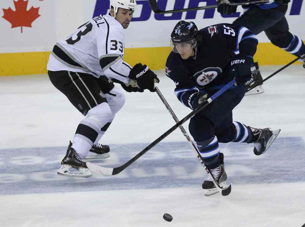 MIKE DEAL / WINNIPEG FREE PRESS
Winnipeg Jets' Mark Scheifele (55) stickhandles around Los Angeles Kings' Willie Mitchell (33) in the second period.