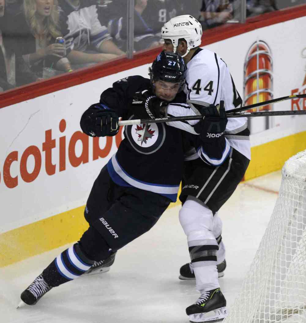 MIKE DEAL / WINNIPEG FREE PRESS
Winnipeg Jets' Eric Tangradi (27) is held back during a scramble behind the net by Los Angeles Kings' Robyn Regehr (44) in the third period.
