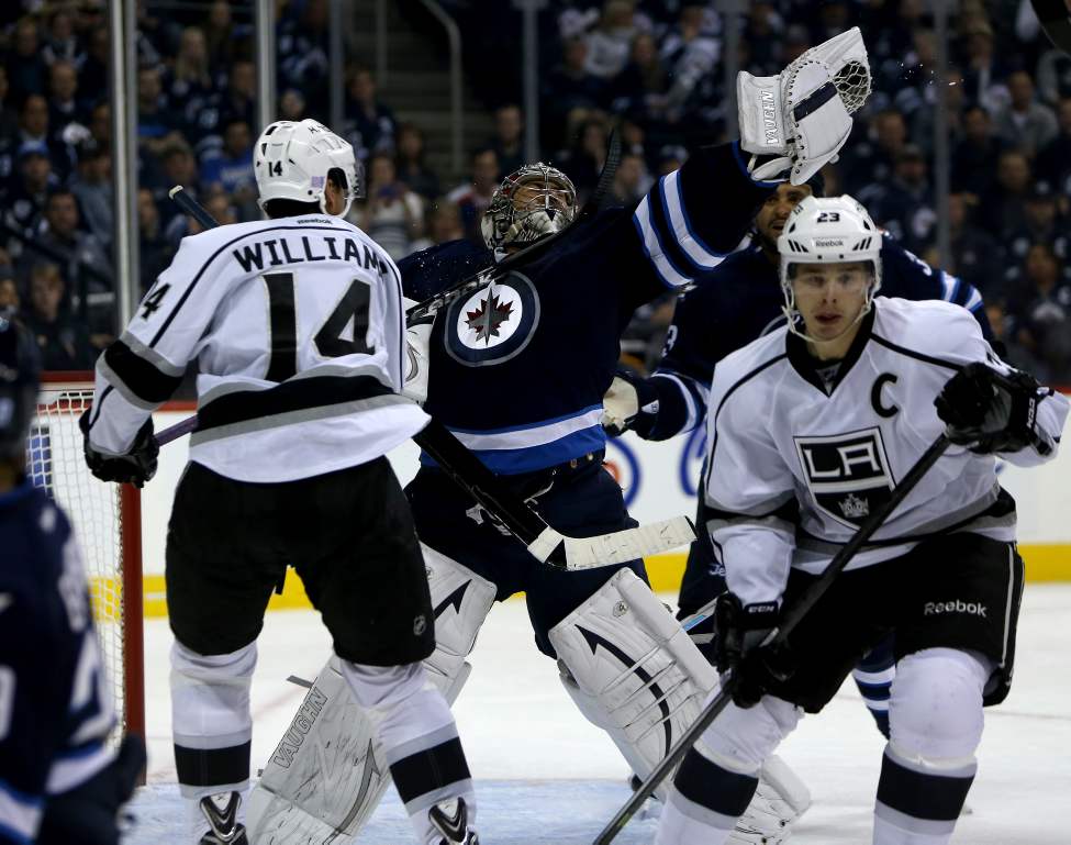 TREVOR HAGAN / WINNIPEG FREE PRESS
Los Angeles Kings' Justin Williams (14) hits Winnipeg Jets' goaltender Ondrej Pavelec (31) with his stick as they both reach for a puck during the third period.