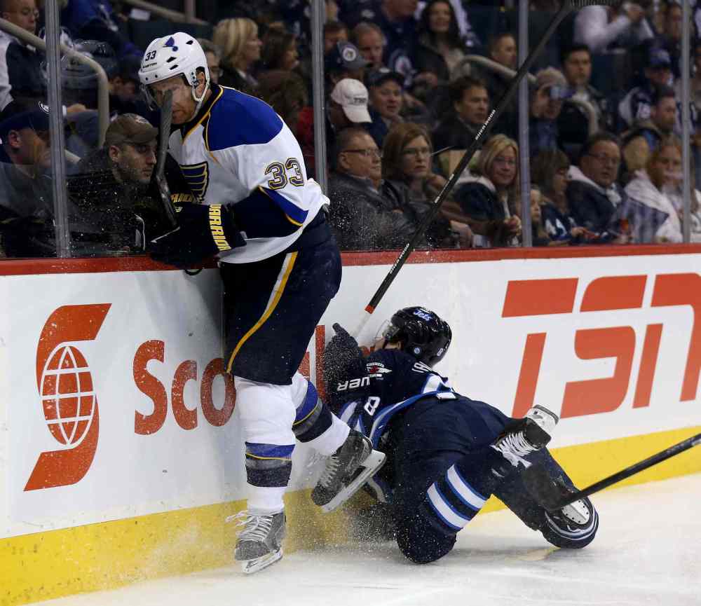 TREVOR HAGAN / WINNIPEG FREE PRESS
Jordan Leopold of the St. Louis Blues plays the puck as Jacob Trouba goes crashing into the boards during the second period.