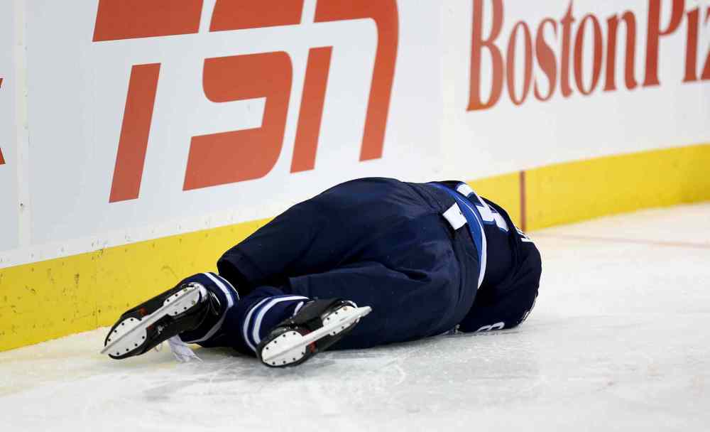 TREVOR HAGAN / WINNIPEG FREE PRESS
Winnipeg Jets' Jacob Trouba lays on the ice after hitting the boards head-first.