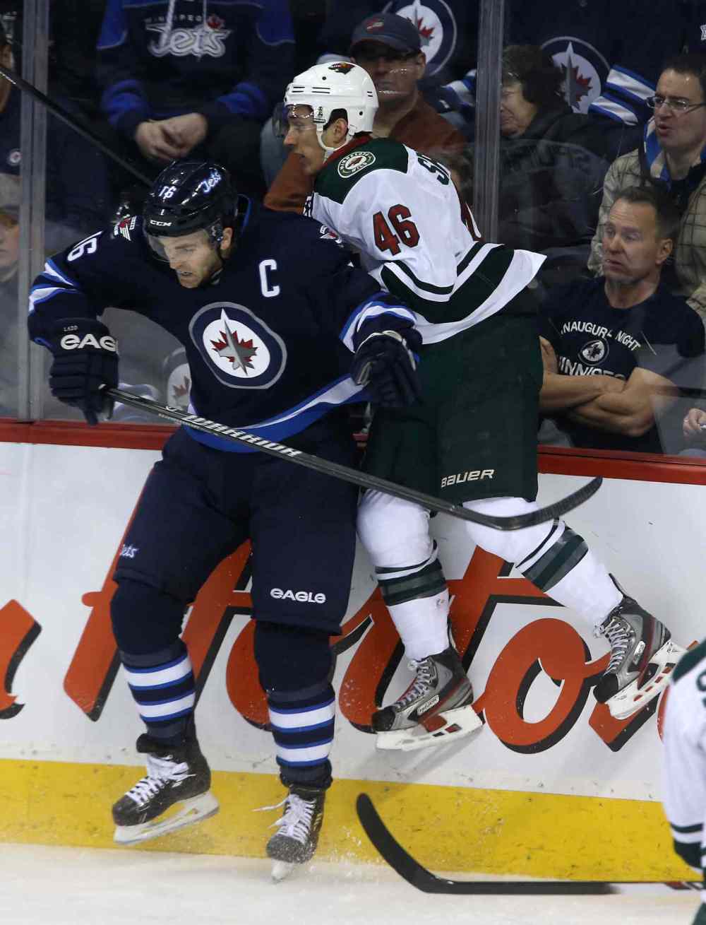 TREVOR HAGAN / WINNIPEG FREE PRESS
Winnipeg Jets forward Andrew Ladd hits Minnesota Wild's Jared Spurgeon during the first period.