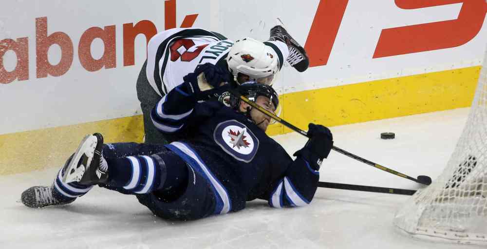 TREVOR HAGAN / WINNIPEG FREE PRESS
Minnesota Wild's Charlie Coyle and Winnipeg Jets defenceman Grant Clitsome collide during the first period.