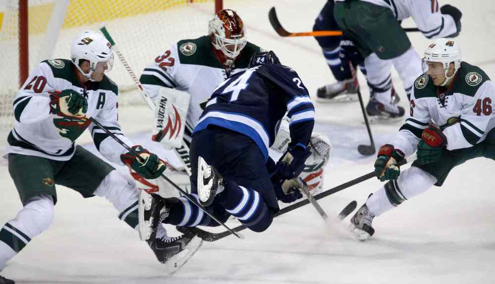 TREVOR HAGAN / WINNIPEG FREE PRESS
Minnesota Wild defenceman Ryan Suter (left) and Jared Spurgeon (right) trip up Winnipeg Jets defenceman Grant Clitsome during overtime.