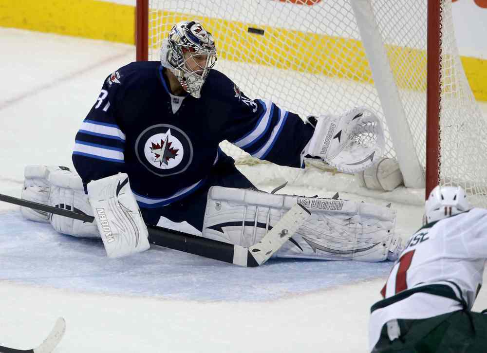 TREVOR HAGAN / WINNIPEG FREE PRESS
Winnipeg Jets' goaltender Ondrej Pavelec is scored on by Minnesota Wild forward Zach Parise during the third period.