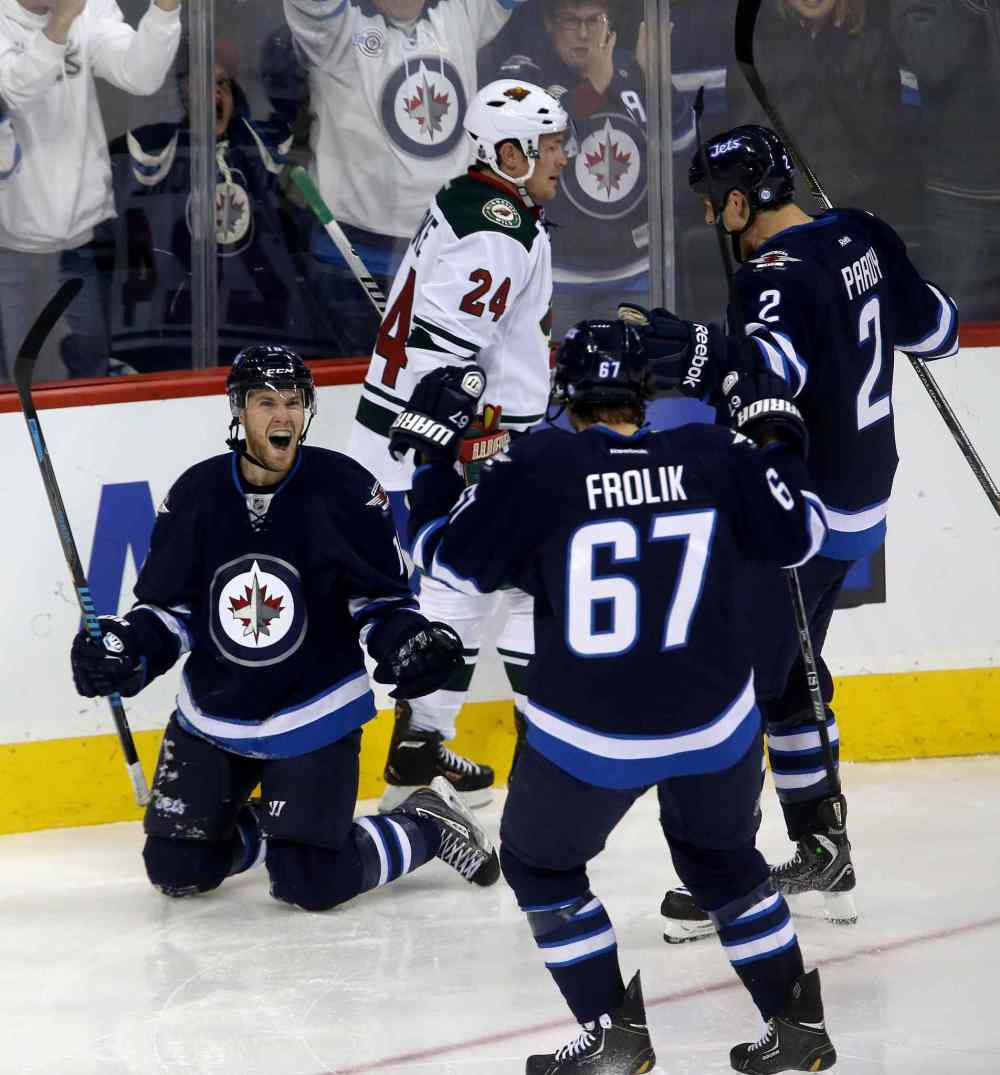 TREVOR HAGAN / WINNIPEG FREE PRESS
Matt Halischuk (left) celebrates with Michael Frolik (67) and Adam Pardy (2) after scoring during the third period as Matt Cooke of the Minnesota Wild looks on.