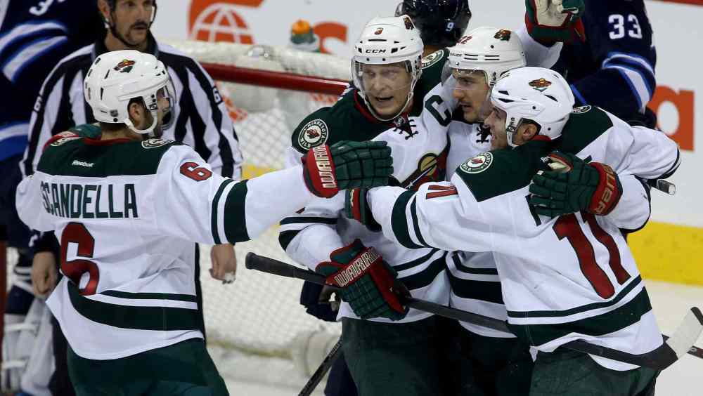 TREVOR HAGAN / WINNIPEG FREE PRESS
Minnesota Wild skaters Marco Scandella (left), Mikko Koivu (centre left), Nino Niederreiter (centre right) and Zach Parise celebrate after Niederreiter scored during the third period.