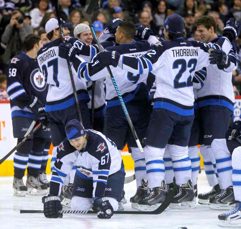 Boris Minkevich / Winnipeg Free Press
Team White celebrates a victory during the skills competition. It's unclear what Michael Frolik (bottom) is up to.