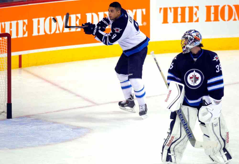 Boris Minkevich / Winnipeg Free Press
Evander Kane bats a puck out of the air and past goalie Al Montoya (right) in the shootout portion of the skills competition.