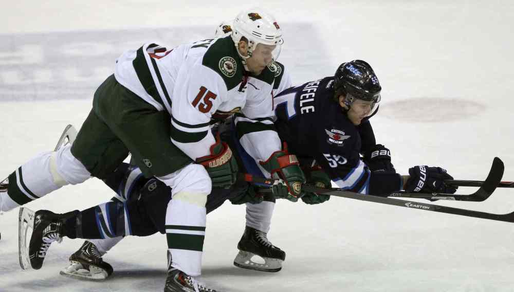 JOE BRYKSA / WINNIPEG FREE PRESS
Winnipeg Jets forward Mark Scheifele (centre) gets hauled down by Minnesota Wild skaters Dany Heatley (left) and Mikael Granlund during the first period.
