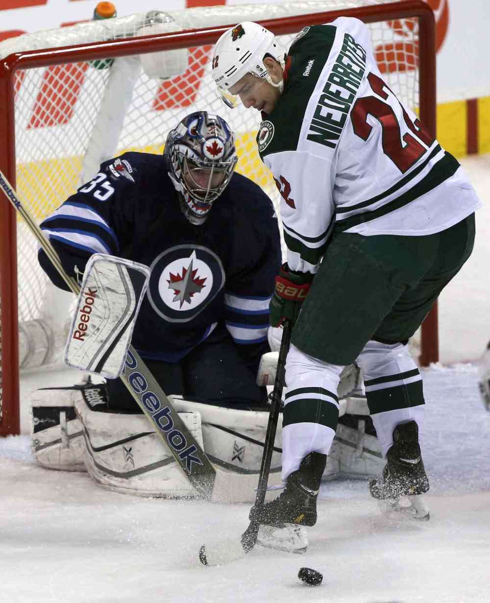 JOE BRYKSA / WINNIPEG FREE PRESS
Winnipeg Jets goaltender Al Montoya is challenged by Minnesota Wild Nino Niederreiter during the first period. Montoya relieved Jets goalie Ondrej Pavelec after the Minnesota Wild scored three goals early in the period.