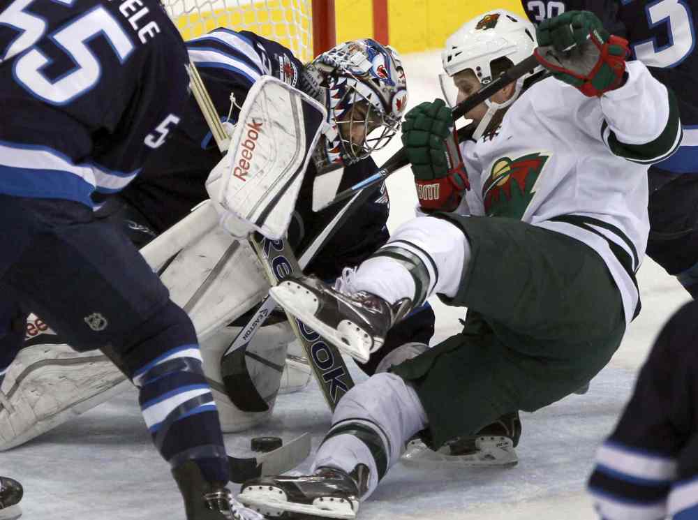 JOE BRYKSA / WINNIPEG FREE PRESS
Winnipeg Jets goaltender Al Montoya is challenged by Justin Fontaine of the Minnesota Wild during the first period.