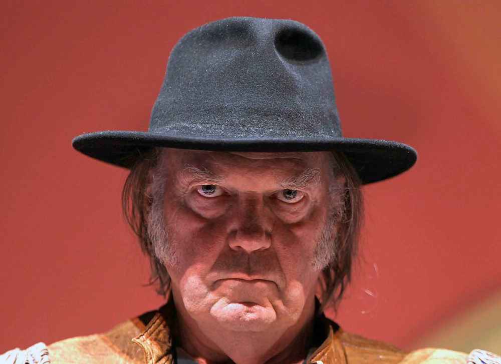Neil Young stares down Joe at a press conference before a concert to raise money and awareness for the Athabasca Chipewyan First Nation Legal Defense Fund in 2014.