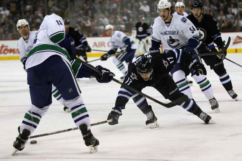 Joe Bryska / Winnipeg Free Press
Winnipeg Jets' James Wright ties it up with Vancouver Canucks' Ryan Stanton, left, during second period Friday.