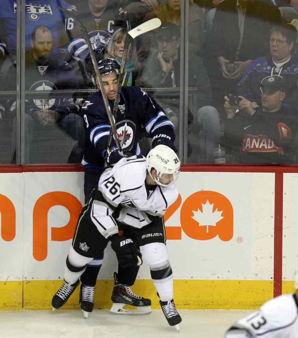Phil Hossack / Winnipeg Free Press
Evander Kane is framed in sticks as he's put into the boards by L.A. Kings' Slava Noyov at the MTS Center Thursday.