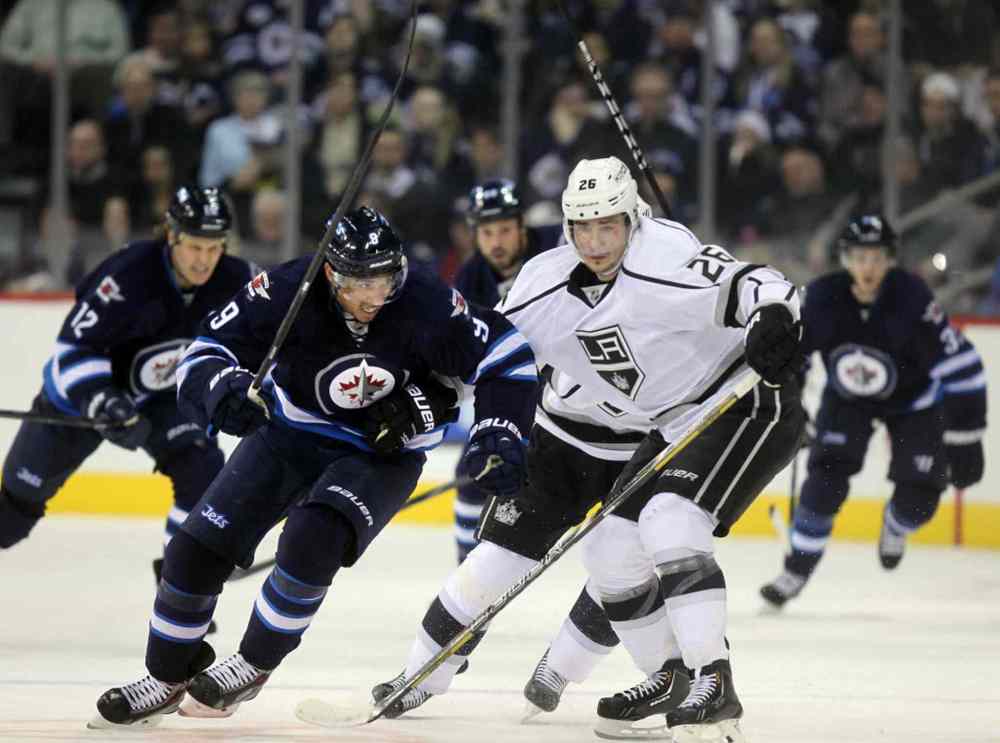 Phil Hossack / Winnipeg Free Press
Evander Kane deeks around Los Angeles King Slava Voynov in second period action to assist Olli Jokinen in opening the scoring.