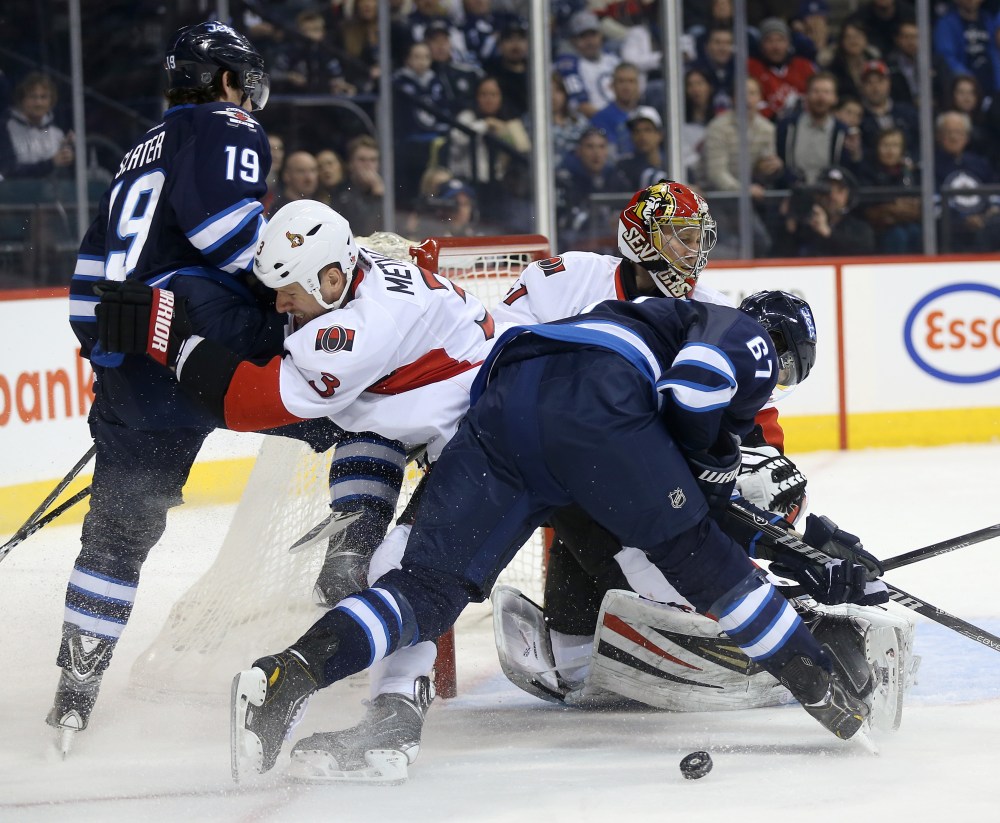 TREVOR HAGAN / WINNIPEG FREE PRESS
Winnipeg Jets' Jim Slater (19) and Michael Frolik (67) battle with Ottawa Senators' Marc Methot (3) in front of goaltender Craig Anderson (41) during second period NHL action.