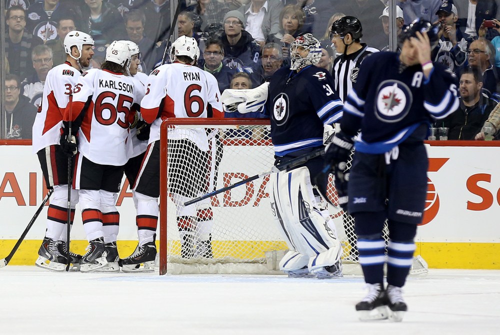 TREVOR HAGAN / WINNIPEG FREE PRESS
The Ottawa Senators' celebrate one of their second period goals on Winnipeg Jets' goaltender Ondrej Pavelec (31) as Mark Stuart (5) looks on.