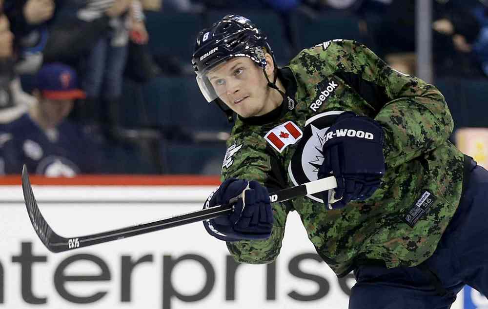 TREVOR HAGAN / WINNIPEG FREE PRESS
Winnipeg Jets' Jacob Trouba (8) fires a shot during warmup while wearing a camouflage jersey on Military Appreciation day prior to the game against the Ottawa Senators', Saturday.
