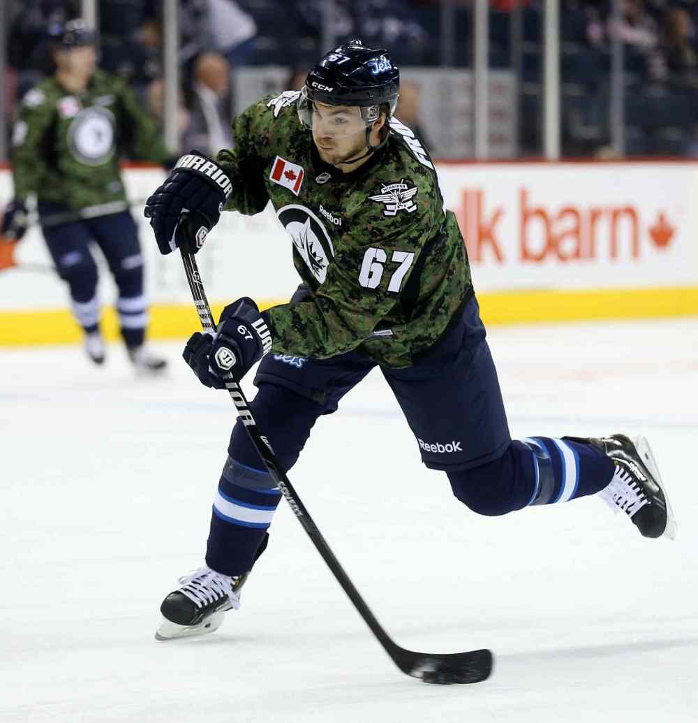 TREVOR HAGAN / WINNIPEG FREE PRESS
Winnipeg Jets' Michael Frolik (67) fires a shot during warmup while wearing a camouflage jersey on Military Appreciation Day prior to the game against the Ottawa Senators', Saturday.