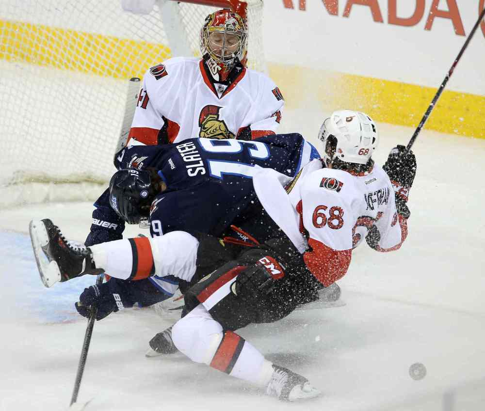 TREVOR HAGAN / WINNIPEG FREE PRESS
Winnipeg Jets' Jim Slater (19) and Ottawa Senators' Mike Hoffman (68) go down in a pile in front of goaltender Craig Anderson (41) during first period NHL hockey action at MTS Centre in Winnipeg, Saturday.