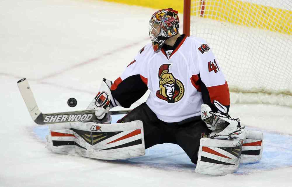 TREVOR HAGAN / WINNIPEG FREE PRESS
Winnipeg Jets' Bryan Little (18) puts the puck past Ottawa Senators' goaltender Craig Anderson (41) during first period NHL hockey action at MTS Centre in Winnipeg, Saturday.