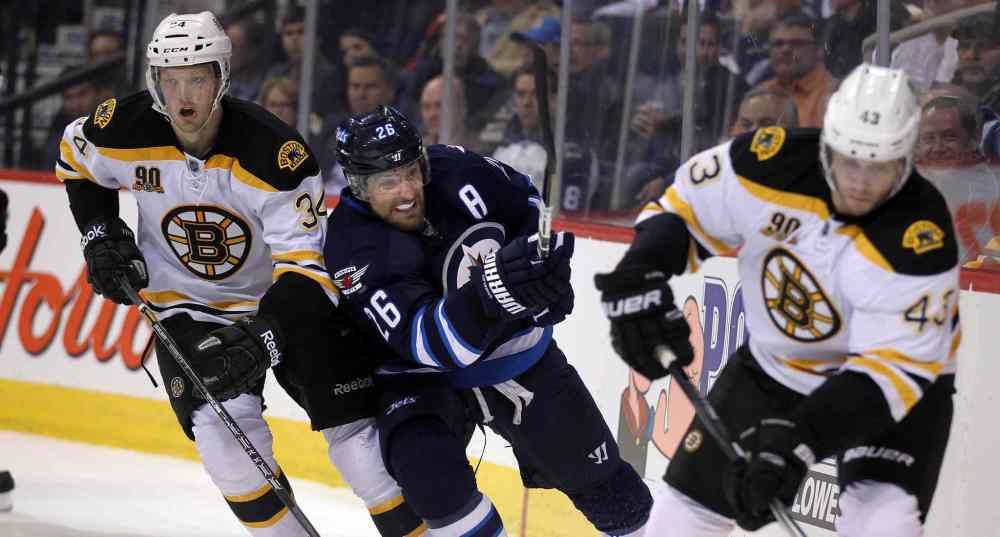 Phil Hossack / Winnipeg Free Press
Winnipeg Jets' Blake Wheeler rushes by Boston Bruins' Carl Soderberg, left, and Matt Bartkowski behind the Bruins net during the second period.