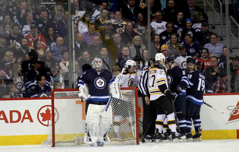 Phil Hossack / Winnipeg Free Press
Winnipeg net-minder Michael Hutchinson watches the replay while other players sort it out behind the net during the second period of Thursday's game.