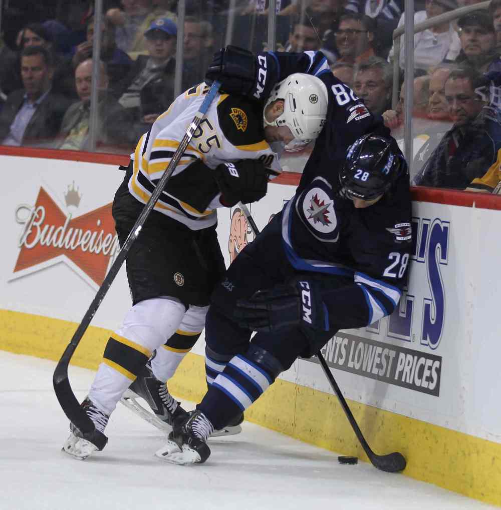 Phil Hossack / Winnipeg Free Press
Bruins' Johnny Boychuk and Jets' Patrice Cormier battle it out behind the Bruins' net during the second period Thursday.