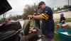 Phil Hossack / Winnipeg Free Press
Tailgaters kick back with some burgers before the Winnipeg Blue Bombers home opener football game Thursday. From left, Cory Rach, Pat Mulville, Kurt Kowalchuk and six-year-old Brady Rach get the grill going.