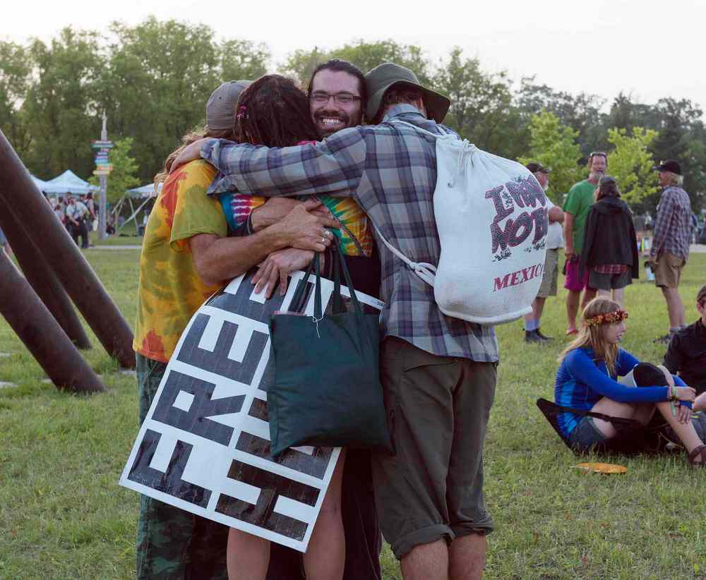 Sarah Taylor / Winnipeg Free Press
Greg Allan feels the love as he delivers free hugs at Folk Fest on Thursday.