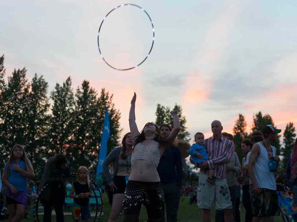 Sarah Taylor / Winnipeg Free Press
Brittany Roginson dances with her hula hoop at Folk Fest on Thursday. She is performing in the fire shows at 1 a.m. Friday and Saturday.