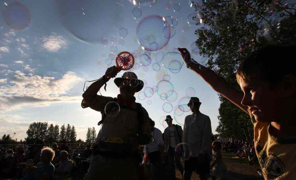 Joe Bryksa / Winnipeg Free Press
Children follow 'The Bubbleman' at the Winnipeg Folk Festival Friday.
