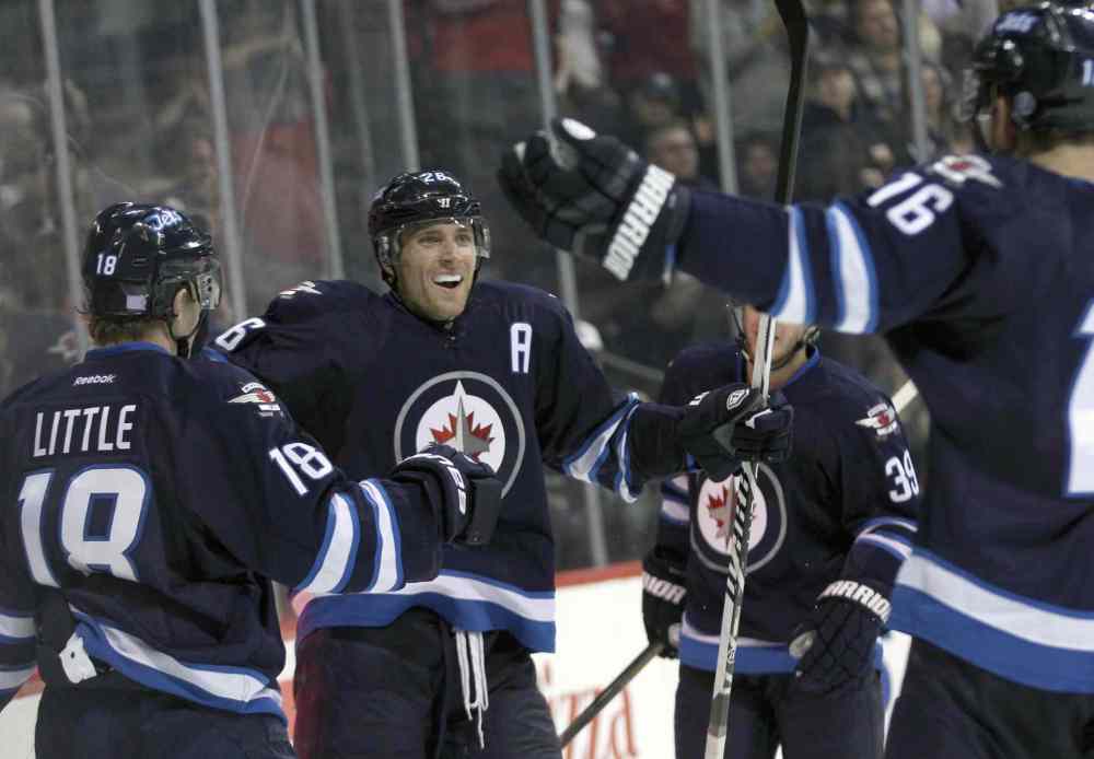 JOE BRYKSA / WINNIPEG FREE PRESS
Winnipeg Jets' Blake Wheeler, Toby Enstrom, and Andrew Ladd, right, celebrate a second-period power play goal by Bryan Little, left.