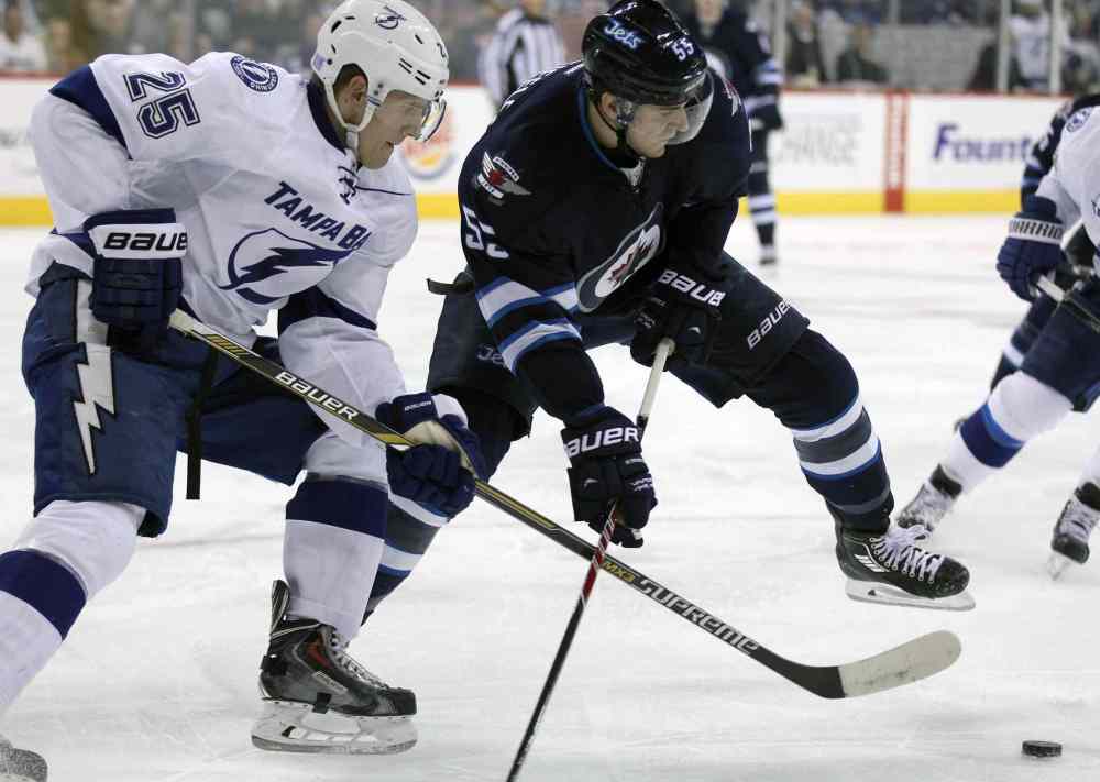 Joe Bryksa / Winnipeg Free Press
Winnipeg Jets Mark Sheifele, right, scrambles for the puck with Tamapa Bay Lightning's Matthew Carle during second period Friday at MTS Centre.