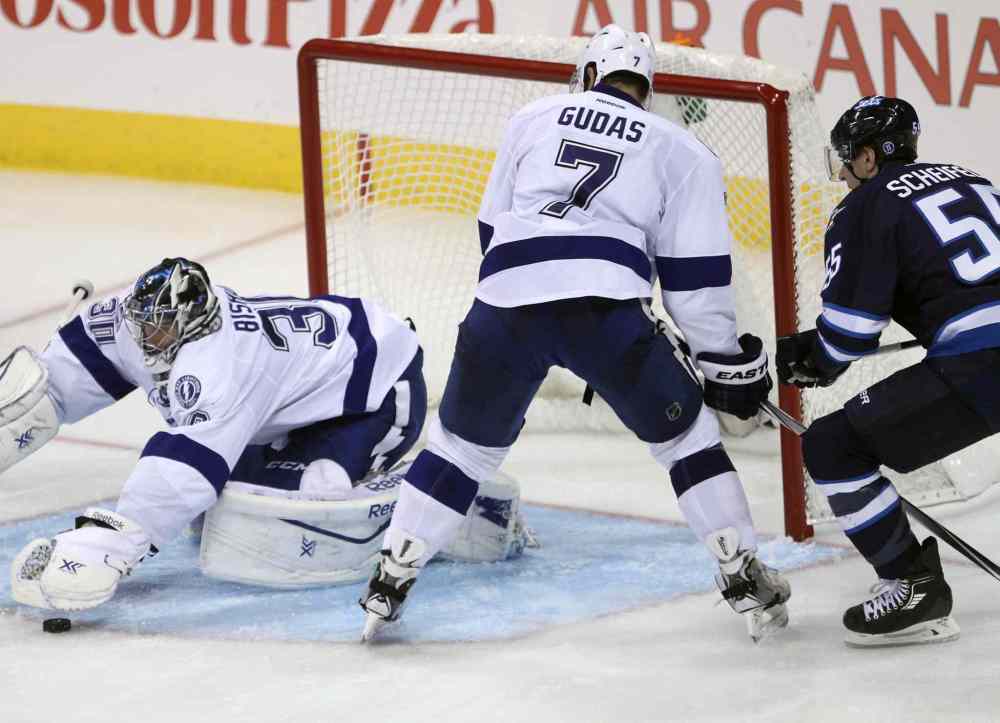 Joe Bryksa / Winnipeg Free Press
Winnipeg Jets Mark Sheifele, right, tries to get a loose puck in front of Tampa Bay goaltender Ben Bishop and defenceman Radko Gudas during third period NHL hockey Friday night at the MTS Centre.